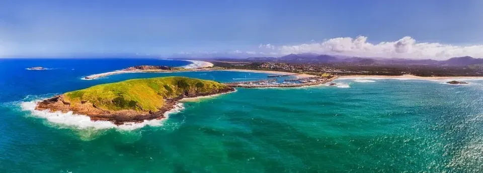 Aerial view of a green island, turquoise ocean and coastline