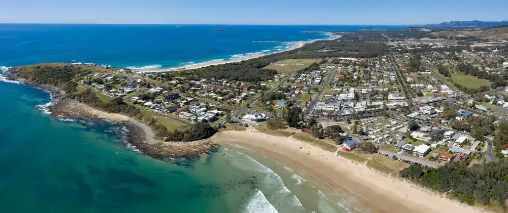 Aerial view of a coastal town beside beaches and blue ocean
