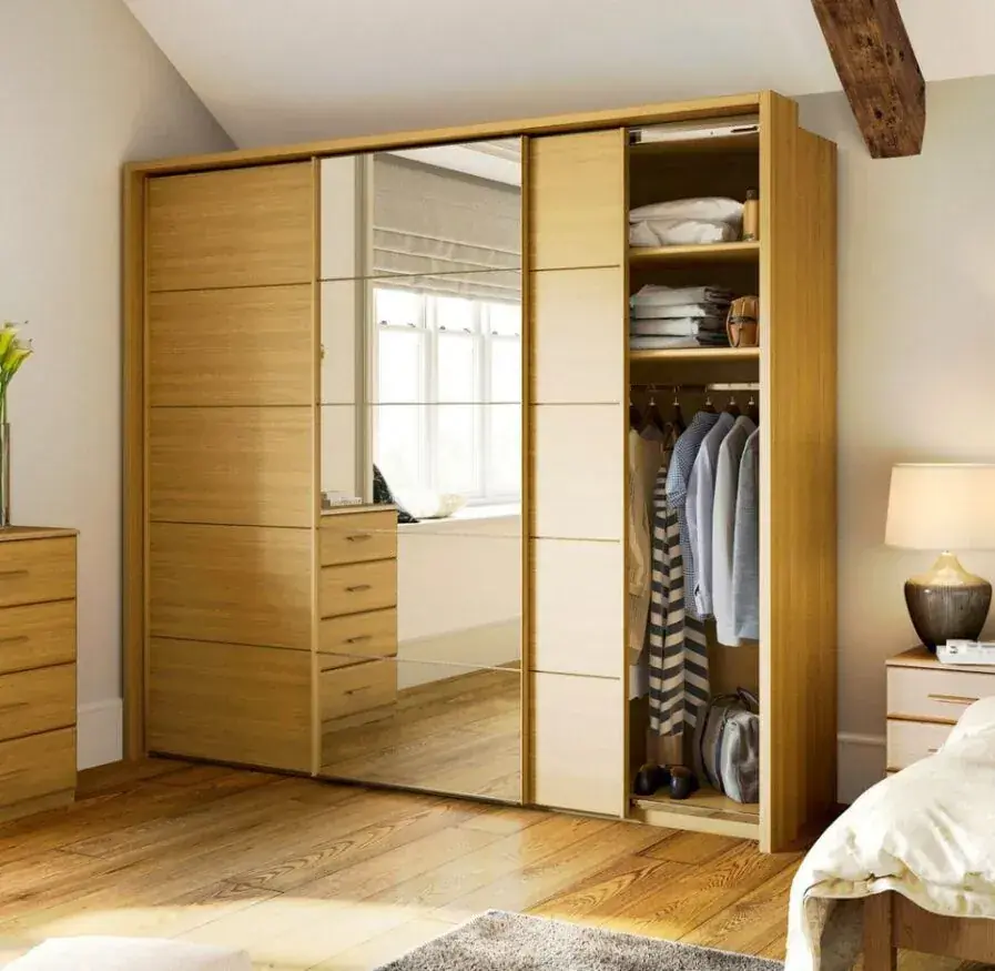 Built-in wardrobe with timber sliding doors, mirror and open clothing storage