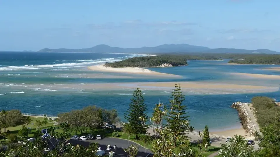 Elevated view across a coastal inlet towards distant hills