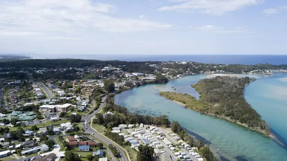 Aerial view of a river mouth, coastal neighbourhood and ocean